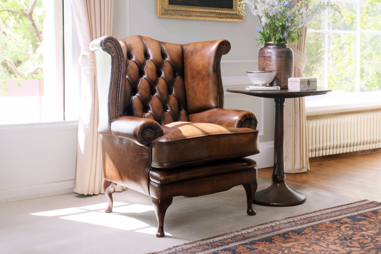Edward leather chesterfield chair featuring soft silhouette and voluptuous form