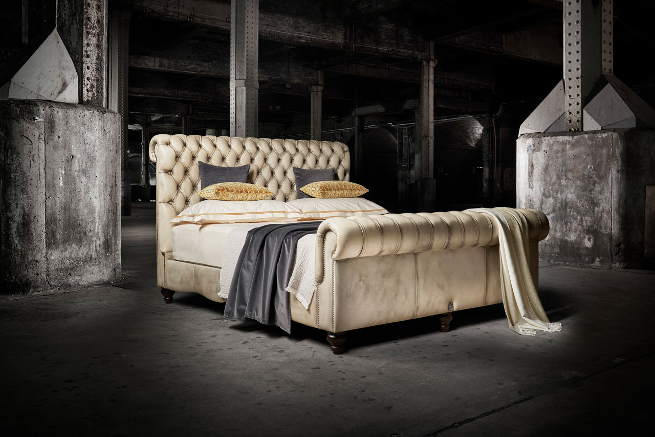 William Blake leather tufted chesterfield bed honouring the artistry of deep-buttoned upholstery with rolled headrest and curved sides