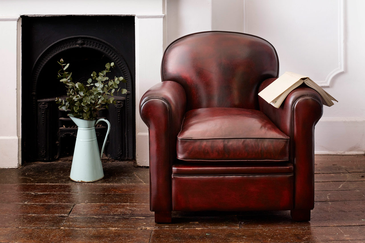 Busby art deco leather chair with arched backrest inspired by traditional busby hat